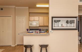 a kitchen with a painting