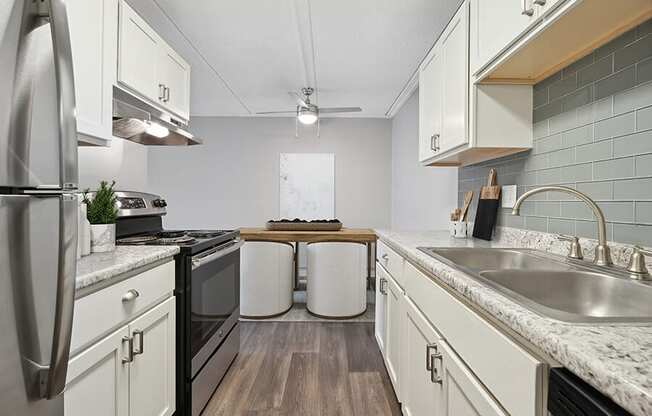 Model Kitchen with White Cabinets and Wood-Style Flooring at Elevate on Parkway, Burnsville, Minnesota