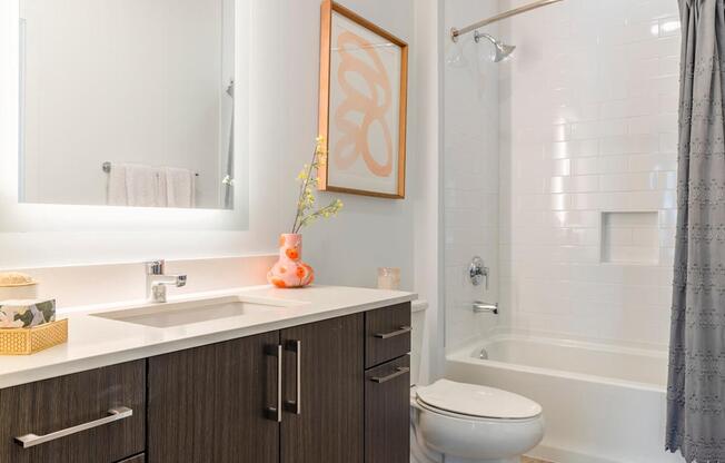 A bathroom with a white sink and a white toilet.