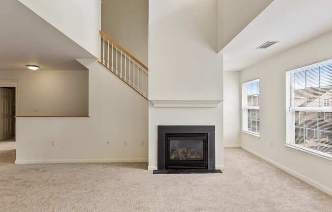 Orchards Apartments Marlborough ma apartment loft style apartments photo of living room with fireplace and stairs with carpet flooring and multiple windows