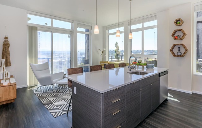an open kitchen with a large island and a view of the city