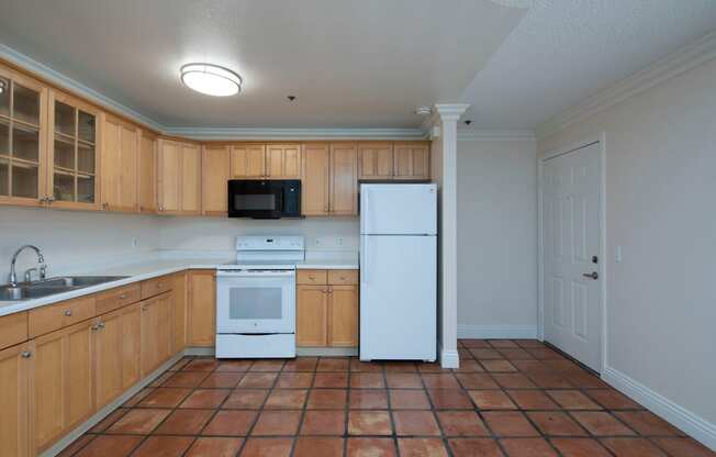 Kitchen with lots of cabinet space and built in appliances at the Atrium Apartments in San Diego, California.