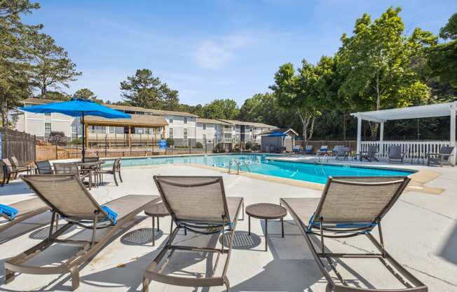 our apartments have a swimming pool with chairs and umbrellas