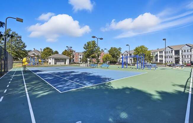 A tennis court with a blue surface and white lines.