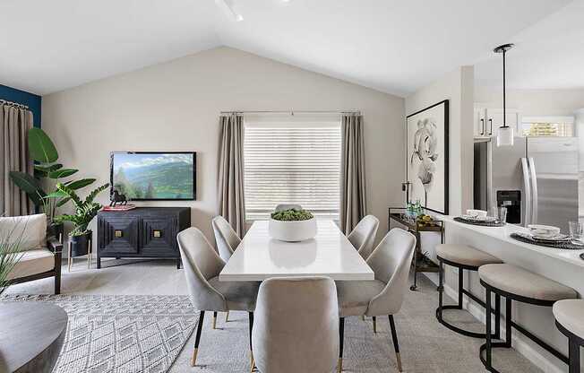 A modern dining room with a large table and chairs.