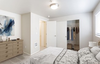 a bedroom with a bed and a closet with a mirror