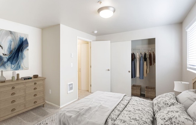 a bedroom with a bed and a closet with a mirror