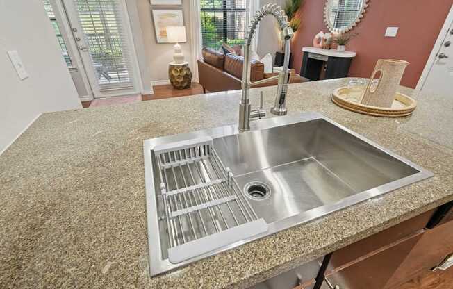 A kitchen counter with a sink and a faucet.
