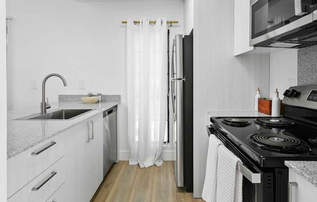 A modern kitchen with a black stove top oven.