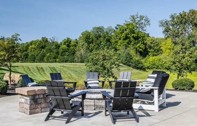 a patio with chairs and a table and a garden