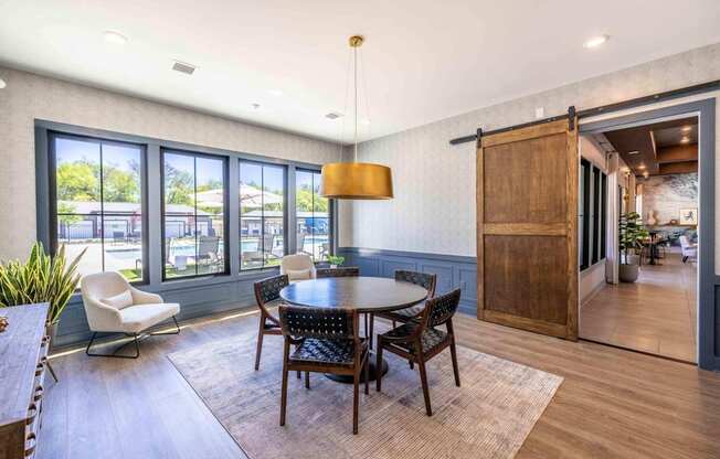A dining room with a round table and chairs.at Evolve at Parkway Apartment Homes, Concord North Carolina