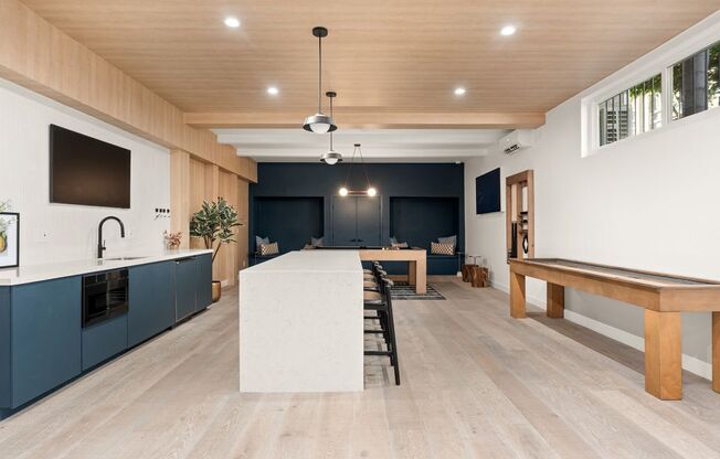 A modern kitchen with wooden cabinets and a white island.