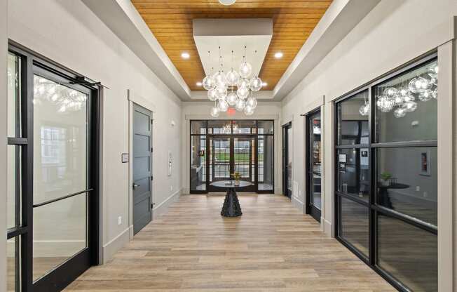 Long hallway with glass doors and a chandelierat Hadley Place Apartments, Pennsylvania, 17025