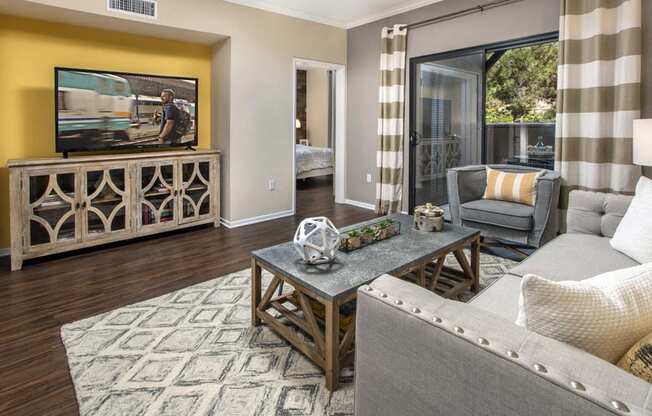 Living area with TV and sliding glass doors to patio