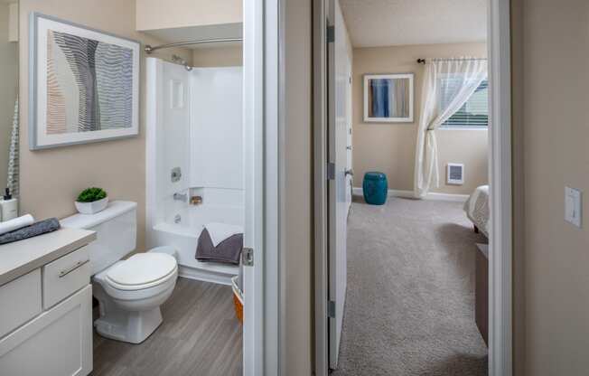a bathroom with a toilet and a bath tub and a shower