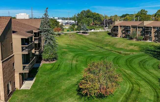 A large grassy area in front of apartment buildings.