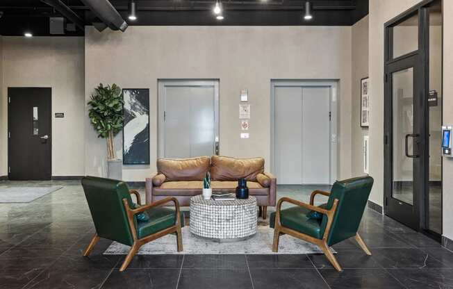 a lobby with a couch and two chairs at EagleRidge Plaza Residences, Fargo, North Dakota