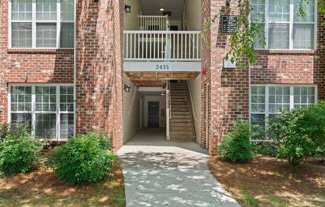 A brick building with the number 2435 on the balcony.