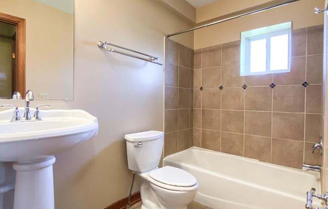 a bathroom with a toilet and a sink and a bath tub