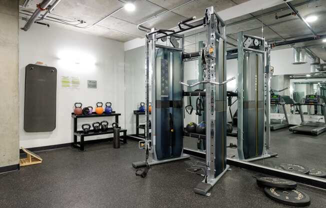 a fitness room with cardio equipment and weights