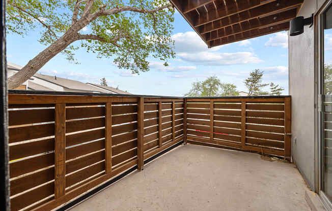 A wooden fence with a tree in the background.