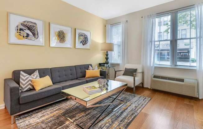 a living room with a couch and a coffee table at Pier Village Apartments, Long Branch, NJ