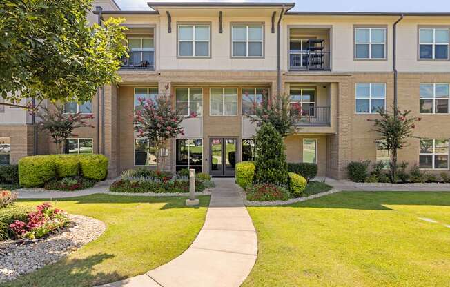A building with a green lawn in front.