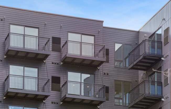 a view of the exterior of a building with multiple balconies