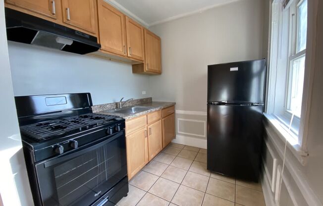 Kitchen with all black appliances - George Spoor Studio