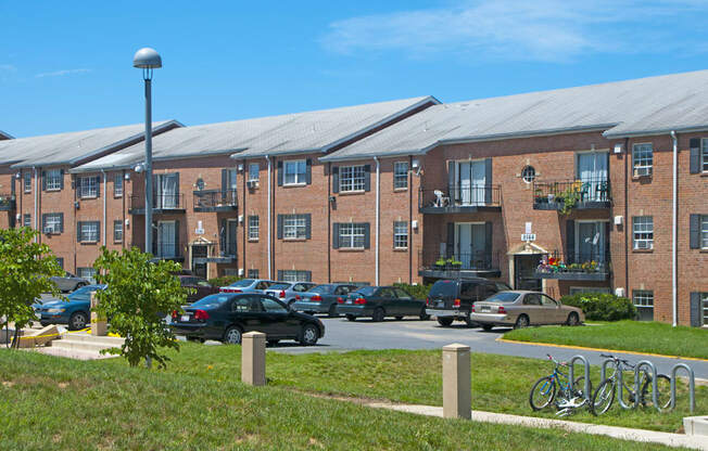 a large brick building with cars parked in a parking lot