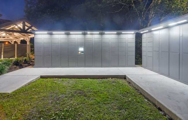 the garage of a home has a white fence and a lawn at Lagniappe of Biloxi Apartment Homes, Biloxi