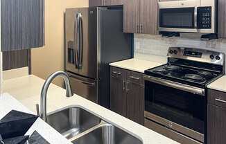 a kitchen with stainless steel appliances and a sink