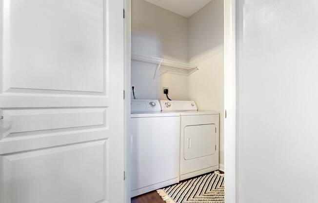 an empty laundry room with a washer and dryer in it