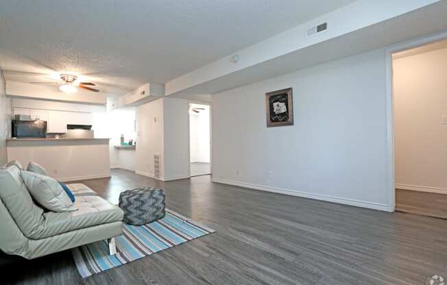 an open living room with a couch and coffee table