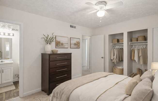 A bedroom with a large bed and a dresser.