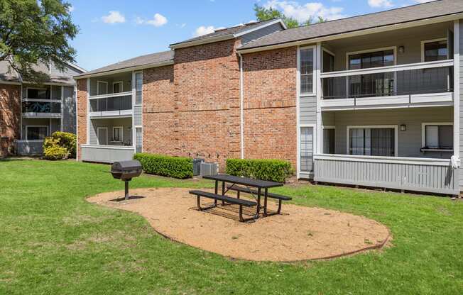 A brick building with a picnic table in front of it.