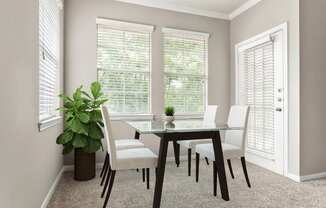 a dining room with a table and chairs and two windows at Villages of Cypress Creek, Houston, Texas