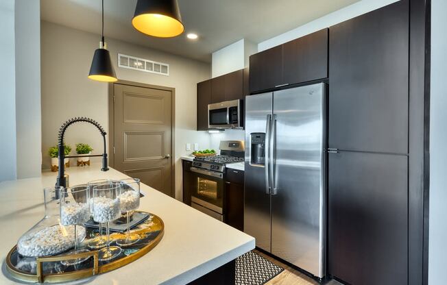 kitchen with an island and a refrigerator at Cuvee, Glendale