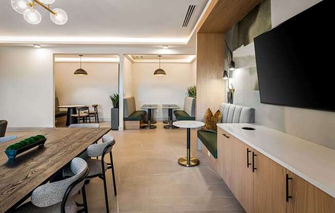 A modern dining room with a wooden table and chairs.