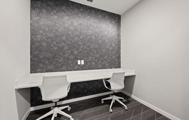 an office with two desks and two chairs