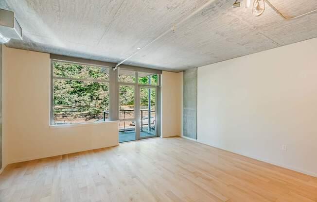 A room with a large window and sliding glass doors.