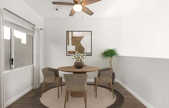 A dining room with a table and chairs.