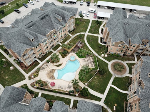 A bird's eye view of a residential area with a swimming pool.