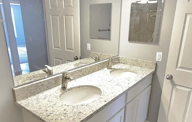 A bathroom with a sink and mirror.