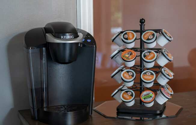 a coffee maker and coffee cups on a table