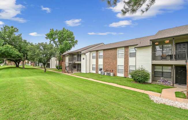 A sunny day at a residential area with houses and green lawns.