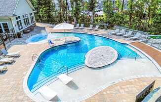 Beach-entry saltwater pool with sundeck and TV