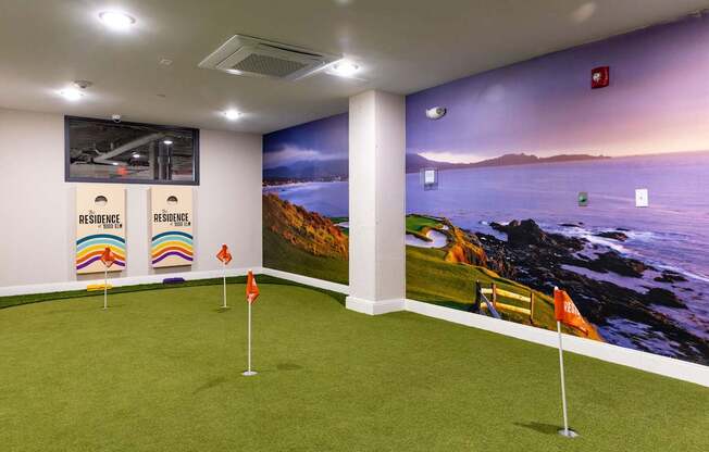 a putting green in a room with a view of the ocean