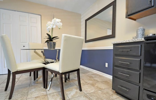a dining room with a table and chairs and a tv