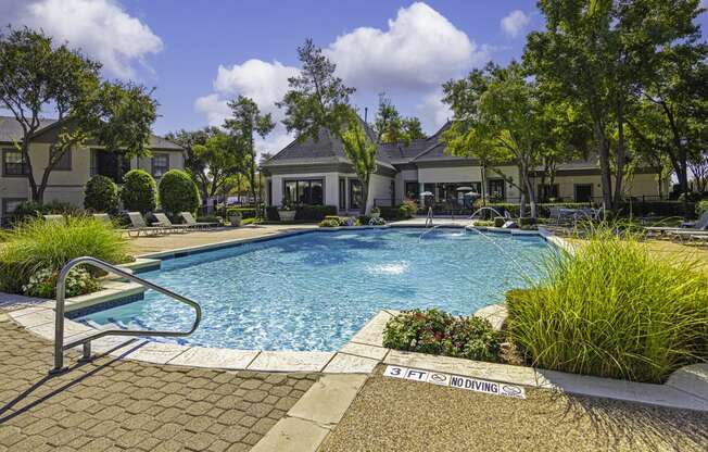 a swimming pool with a building in the background